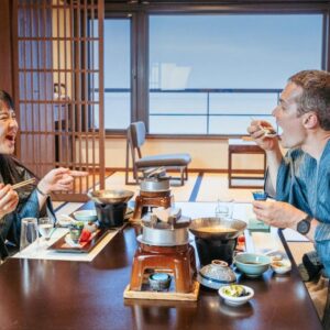 Couple in yukata dining at low table in tatami room with shoji screens at Awakan, Hyōgo, Kansai