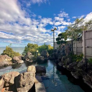 Rock-lined outdoor bath with sea and garden views at Donkairo, Hyōgo, Kansai