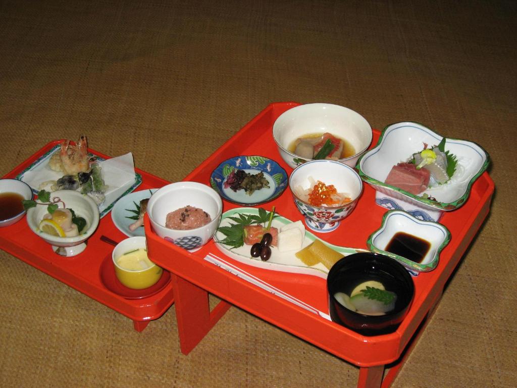 Traditional meal trays Gyokuzoin Nara Red lacquer trays with assorted small dishes on tatami at Gyokuzoin in Nara