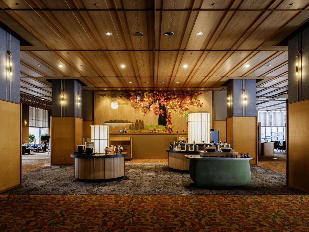 Lobby with floral display HanaMOMIJI Hokkaidō Spacious wooden-ceiling lobby with reception desk and central floral arrangement at HanaMOMIJI Hokkaidō