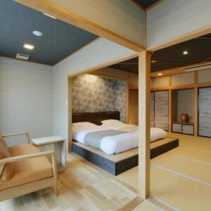 Tatami flooring with raised Western-style beds, seating area and sliding fusuma doors at Hanasuishou, Yamanashi, Chūbu, Japan