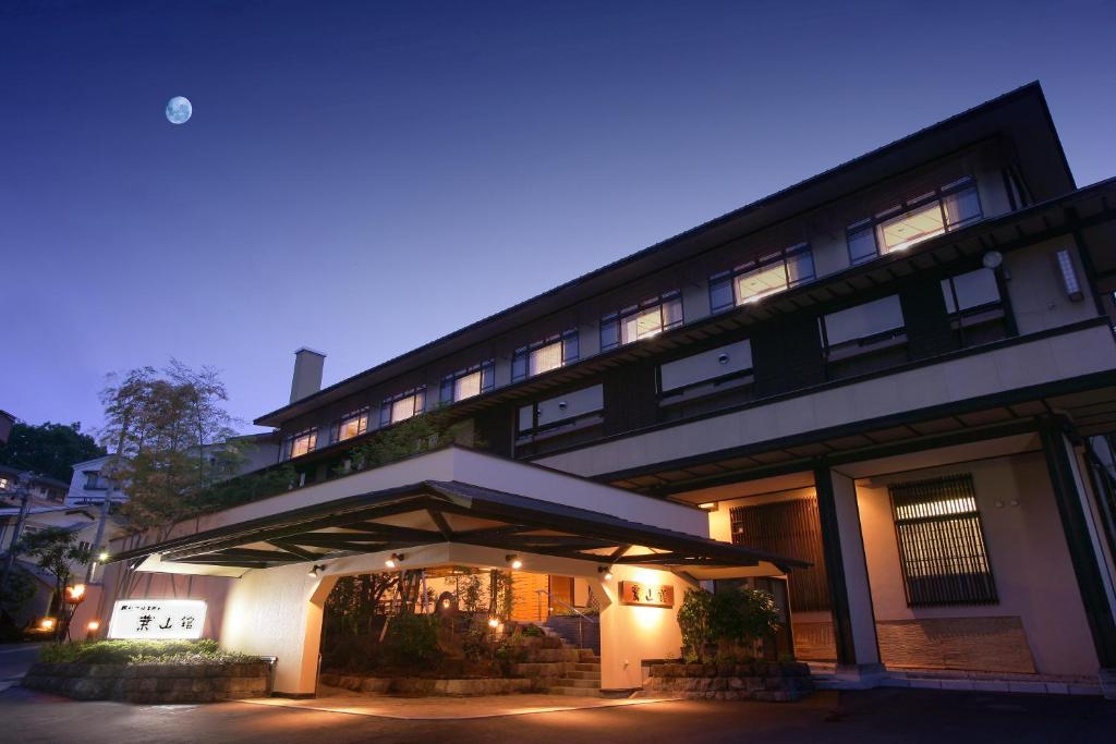 Dusk exterior Hayamakan Ryokan Yamagata Evening facade with lit entrance and moon above, Hayamakan ryokan in Yamagata, Tōhoku, Japan