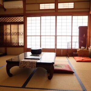 Traditional tatami room with low table and shoji screens at Hinodeya in Shizuoka, Chūbu, Japan
