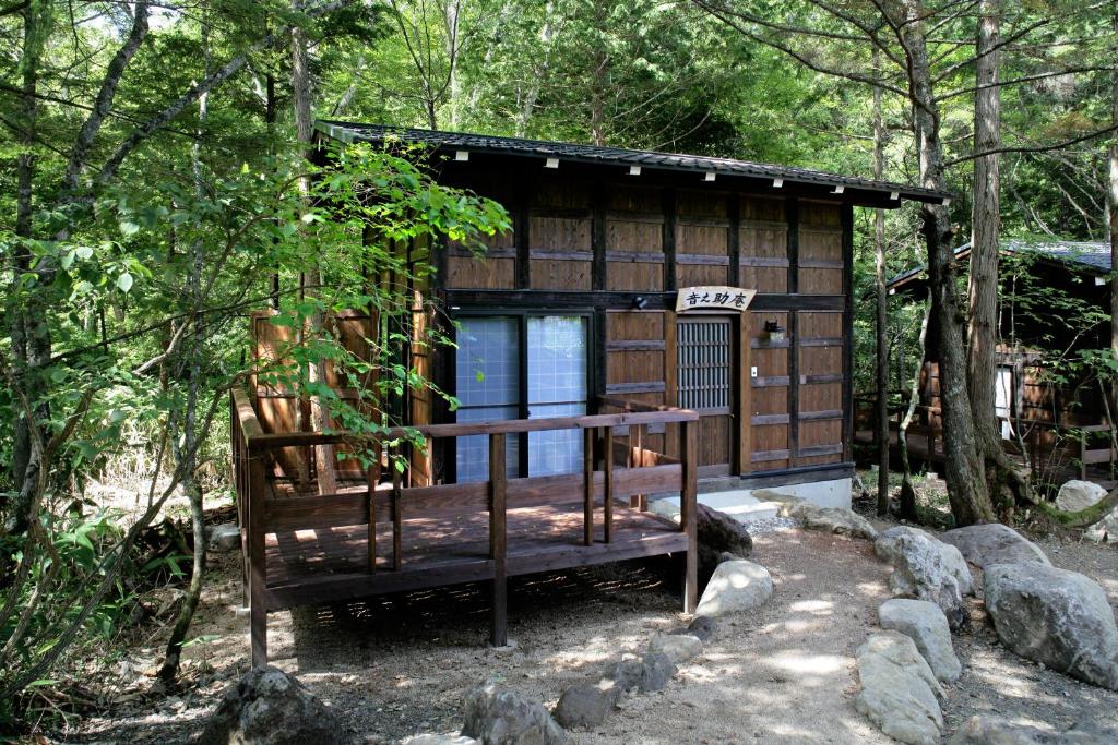 Wooden cabin at Hirayunomori, Chūbu Gifu Wooden guest cabin with deck among trees at Hirayunomori in Chūbu, Gifu, Japan
