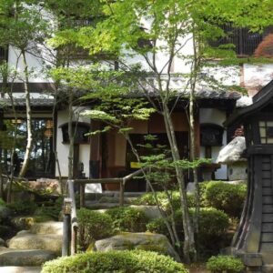 Moss-covered garden with stone lanterns and stepping stones at Hotakajo in Nagano, Chūbu region