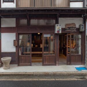 Wooden facade with sliding doors at Itsumoya on a quiet Hiroshima street