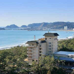 Coastal ryokan building by pine grove and sandy beach at Kamogawakan in Chiba, Kantō
