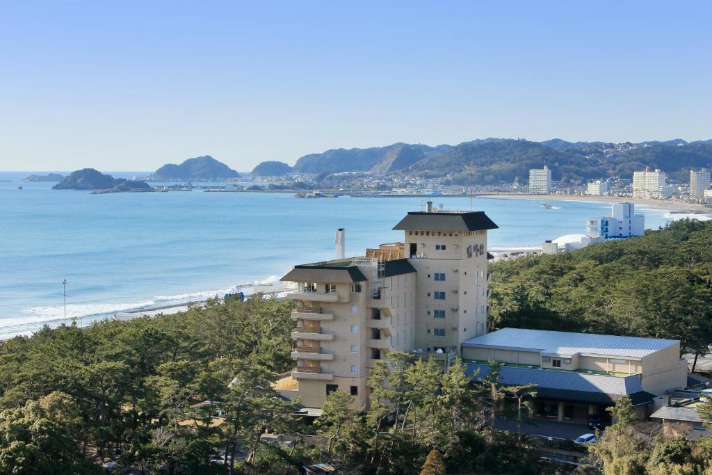Ocean view at Kamogawakan Chiba Kantō Coastal ryokan building by pine grove and sandy beach at Kamogawakan in Chiba, Kantō