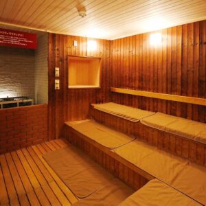 Interior wood-paneled sauna with tiered bench seats and cushions at Kangetsuen in Hokkaidō