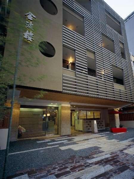 Ryokan entrance facade Kinparo Kyoto Exterior of Kinparo ryokan with slatted multi-story facade, kanji signage and ground-level entrance on Kyoto street