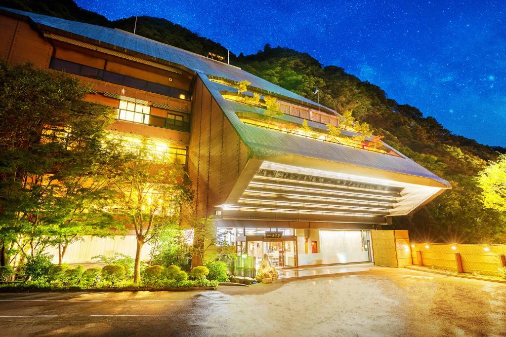 Illuminated entrance Konjakutei Fukushima Night view of Konjakutei entrance with lit canopy and hillside backdrop