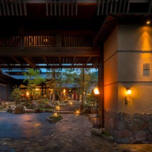 Evening entrance courtyard with lanterns and stone path at Kurotake in Nagano