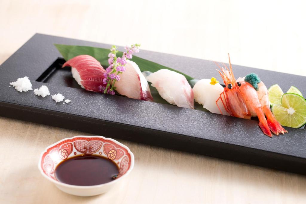 Nigiri sushi platter Matsusaki Ishikawa Japan Assorted nigiri sushi on black platter with soy sauce bowl at Matsusaki ryokan in Ishikawa, Chūbu, Japan
