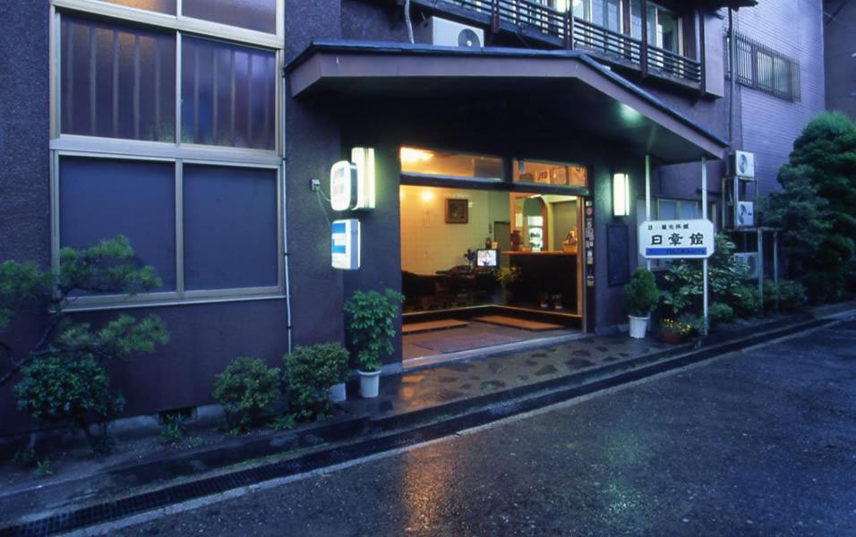 Ryokan entrance Nisshokan Mie Kansai Wet evening street and lit entrance showing reception area at Nisshokan ryokan in Mie, Kansai