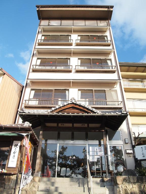 Traditional ryokan facade Sakuraya Chūgoku Hiroshima Multi-story ryokan entrance with wooden detailing at Sakuraya, Chūgoku, Hiroshima, Japan