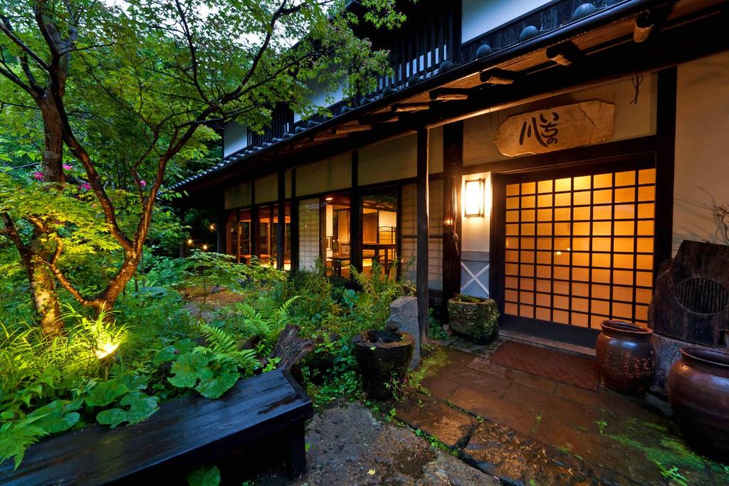 Lush Garden Entrance Sen-no-Mori Kumamoto Japan Evening lit shoji entrance with stone path and verdant garden at Sen-no-Mori in Kumamoto, Kyushu