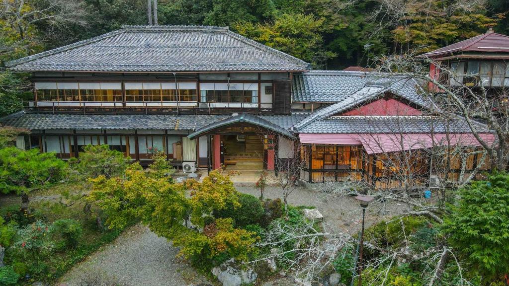 Aerial view of Senzairou ryokan Gifu Japan Traditional wooden ryokan building with garden and mountain foliage at Senzairou in Gifu, Chūbu region