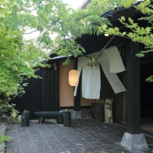 Wooden entrance with noren and lantern at Shinwaen ryokan, Kumamoto, Kyūshū