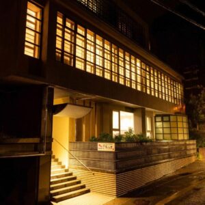 Night exterior with lit windows and entrance steps at Suizansou in Hyōgo