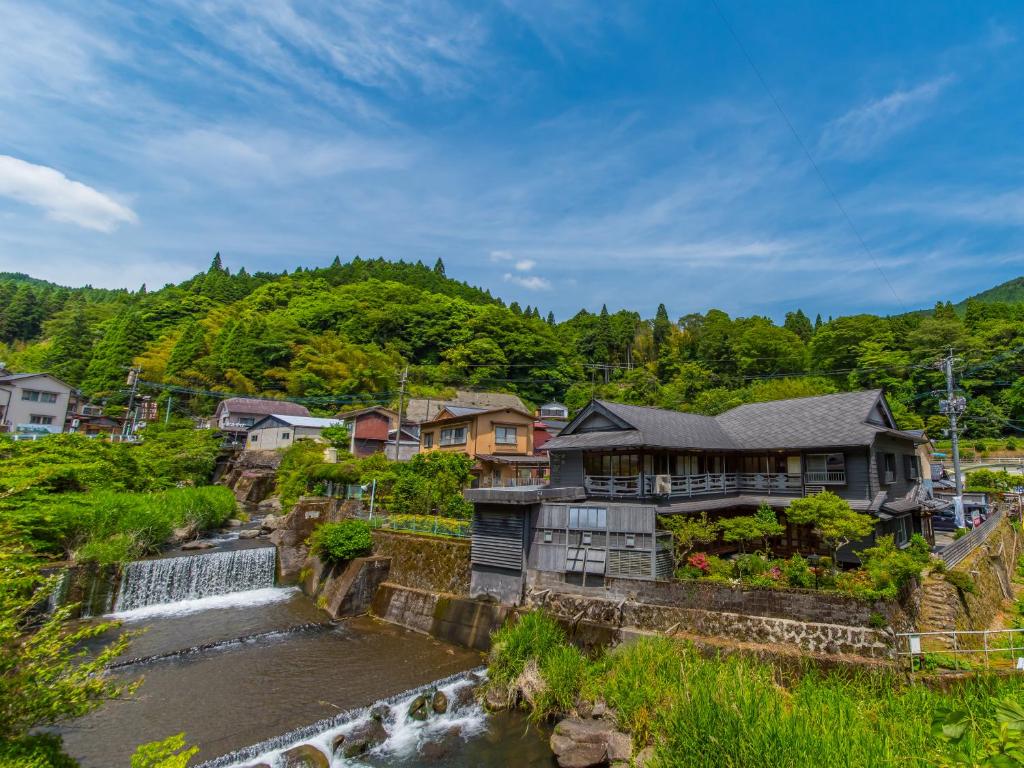 Riverside Wooden Ryokan Takaosou Ōita Riverside wooden buildings beside a cascading stream at Takaosou, Ōita, Kyūshū, Japan