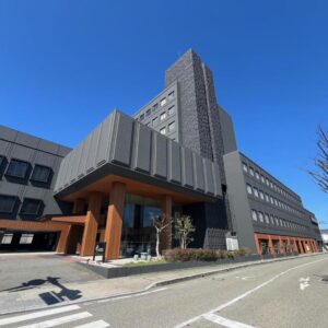Exterior of Tokigasane ryokan with multi-story facade and street entrance in Ishikawa, Chūbu Japan