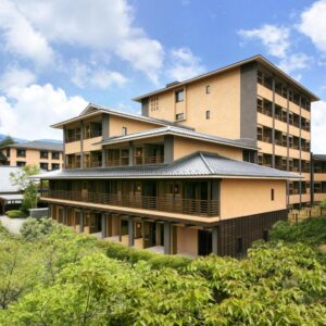 Multi-story ryokan exterior with balconies and greenery at Tokinoniwa in Gunma, Kantō