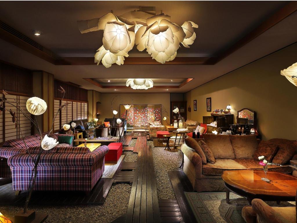 Cozy lounge at Tsukinoike Ryokan Yamagata Warm-lit lounge with sofas, shoji screens and decorative lanterns at Tsukinoike in Yamagata Tōhoku