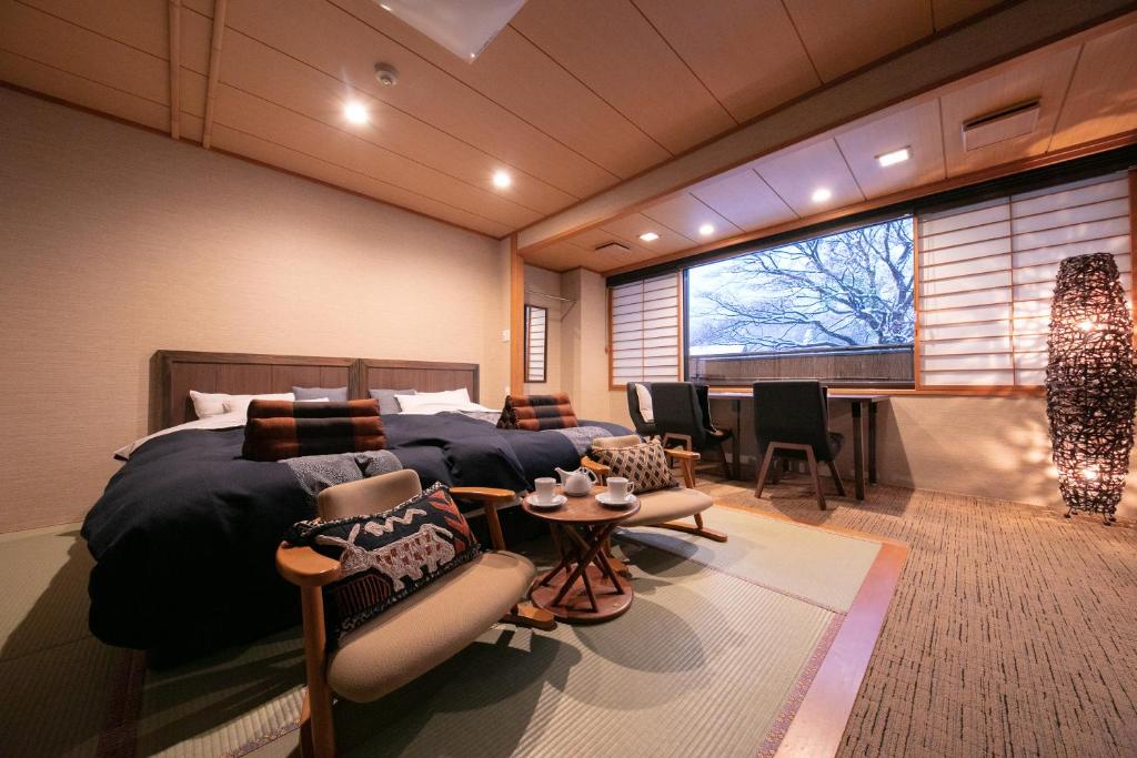 Tatami sitting room Wakamatsuya Yamagata Tōhoku Tatami seating area with low table and twin beds at Wakamatsuya in Yamagata, Tōhoku, Japan