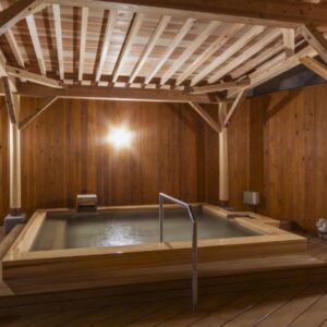 Indoor wooden bath with exposed beams at Yanagiya ryokan in Wakayama Kansai