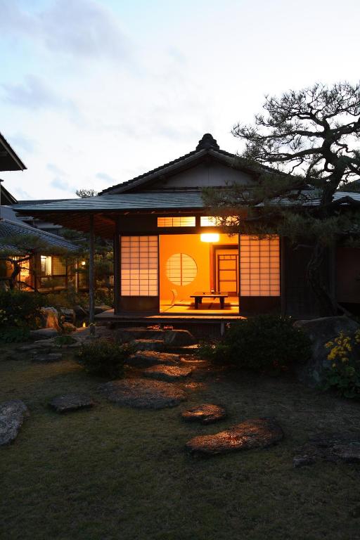 Illuminated shoji entrance Yoyokaku Saga Kyushu Evening view of a lit shoji facade and stone garden path at Yoyokaku in Saga, Kyushu