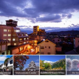 Rooftops and illuminated streets with Yumotoya building and distant mountains under a twilight sky in Nagano