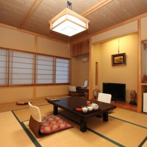 Tatami room with low table, shoji screens and alcove at Yusakaso in Kanagawa, Japan