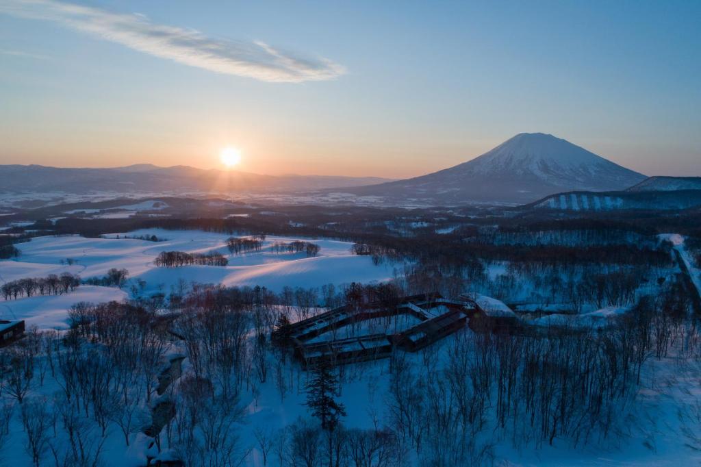 Snowy sunrise over Zaborin Hokkaidō Aerial view of snow-covered Zaborin grounds with distant mountain and sunrise in Hokkaidō