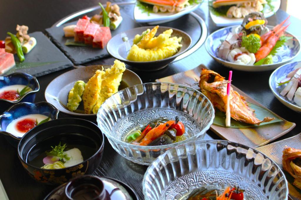 Traditional Ryokan Meal at Sakamotoya Kyoto Assorted small Japanese dishes including sashimi, tempura and grilled fish in a ryokan dining setting in Kyoto