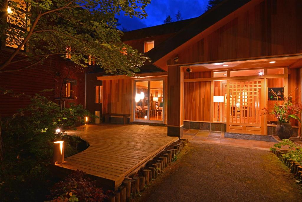 Illuminated Wooden Entrance Yunomori Okunikko Tochigi Warmly lit wooden entrance and deck at Yunomori, Okunikko Yumoto Onsen in Tochigi at dusk