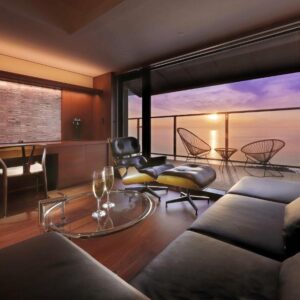 Modern lounge with glass doors, balcony and sea view at Yūsuitei Isagoya Yamagata