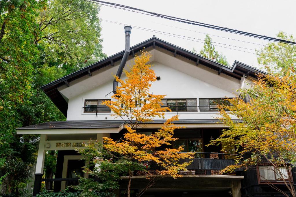 Autumn facade Okara Sansō Nagano Japan Two-story ryokan facade with orange autumn leaves at Okara Sansō in Nagano, Chūbu region